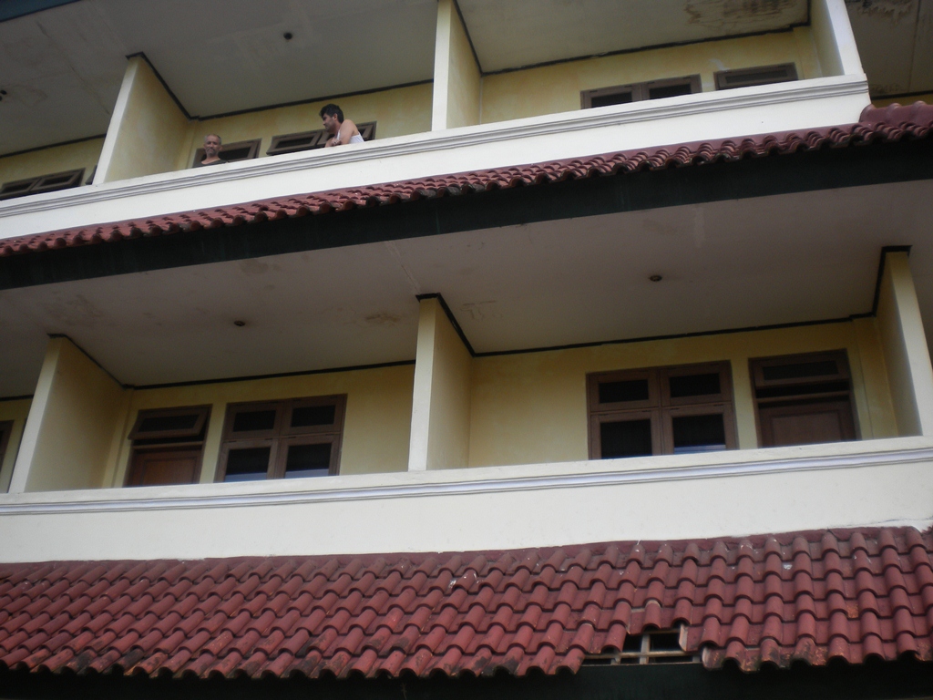 A building used as an interim detention facility (the missing tiles in the roof are the result of an escape attempt, when an asylum seeker jumped) - Antje Missbach Life and death in immigration detention